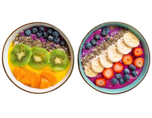 Top-down view of two vibrant smoothie bowls arranged in rainbow layers with colorful toppings