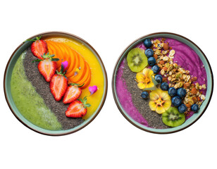 Top-down view of two vibrant smoothie bowls arranged in rainbow layers with colorful toppings
