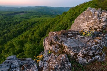 Mountain landscape with rocks, on top of mountain, sunlit hills, illuminated sky. Picturesque landscape Vysoka of Male (Little) Karpaty, Slovakia, Slovakia mountain range.