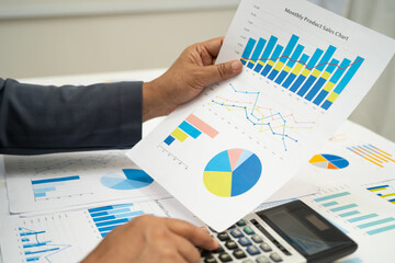 Asian business woman working with financial graph.