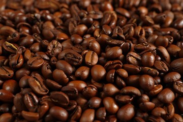 Obraz premium Rich brown roasted coffee beans close up detailed texture dark