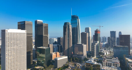 Obraz premium Los Angeles city. LA downtown aerial view. Los Angeles skyline. LA streets. Los Angeles from a top view. Downtown towers of Los Angeles. Panoramic scene of LA skyline. Blue sky frames the city below.