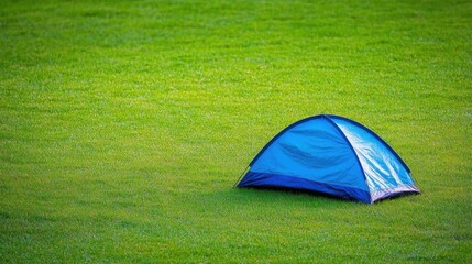 Blue Tent Resting On green Meadow, Outdoor Recreation And Relaxation