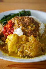 Nasi Padang Kikil, Indonesia, captured on July 13, 2025. Steamed rice served with spicy Padang-style beef tendon curry, vegetables, sambal, and rich coconut gravy for bold Minang flavor