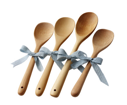 Four wooden spoons are tied together with a ribbon