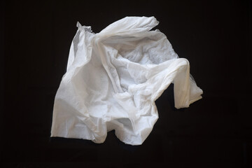White crumpled tissue paper on a dark background