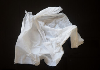 White crumpled tissue paper on a dark background