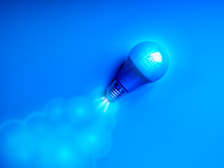 AI, artificial intelligence growth, business startup, smart brain, creative idea and inspiration concept. AI chip icon on blue electric lightbulb, as a rocket jet launch, take off on blue background.