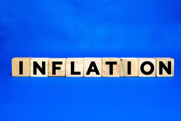 Obraz premium wooden cube with the word INFLATION. Economics, and inflation control, money inflation.