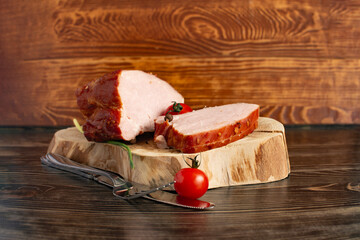 Two pieces of fresh meat, packed carbonate and pastrami, cutlery and cherry tomatoes in close-up...