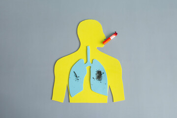 The silhouette of a man with diseased lungs, harmful smoke from cigarettes and a red cigarette at...