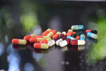 Illustration of various capsules used for treatment against a dark background