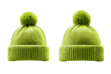 Two green hats with pom poms on them