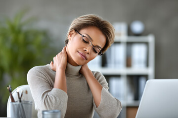 Fototapeta premium Woman office worker neck pain stress fatigue, sitting at desk with laptop, touching neck, feeling discomfort, modern workspace