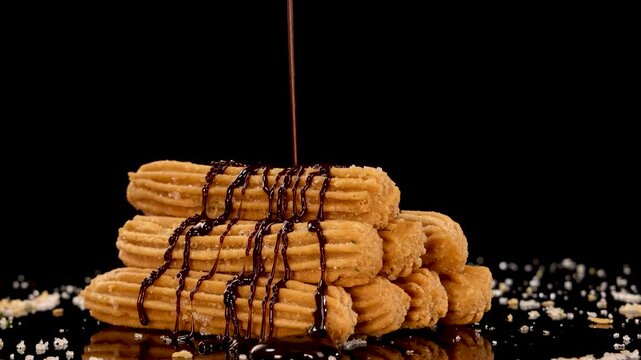 Chocolate Sauce Drizzling Over Spanish Churros Stack