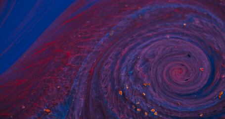 Ink whirl. Paint fluid. Defocused blue purple red colorful flowing golden yellow water floating on...