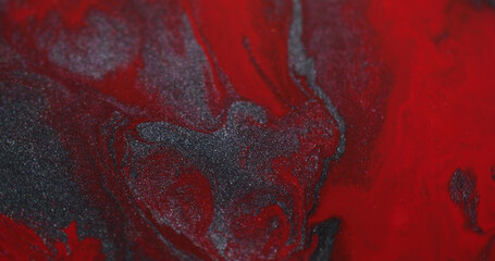 Splatter liquid. Flowing paint. Defocused red maroon silver color water sparkling stains floating on abstract creative background.