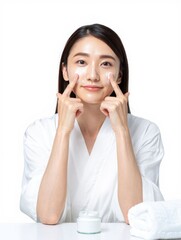 Woman Applying Cream on Face in Studio Setting