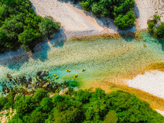 Rafting and kayaking place on the river. Kayakers in colorful life jacket paddling in Soca river, Bovec in Triglav National Park, Slovenia