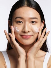 Young Woman Applying Skincare Cream on Face