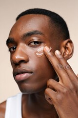 Man Applying Skincare Cream on Face