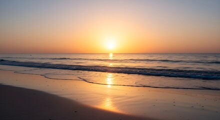 A scenic view of the ocean at sunset with the sun reflecting on the water and wet sand.