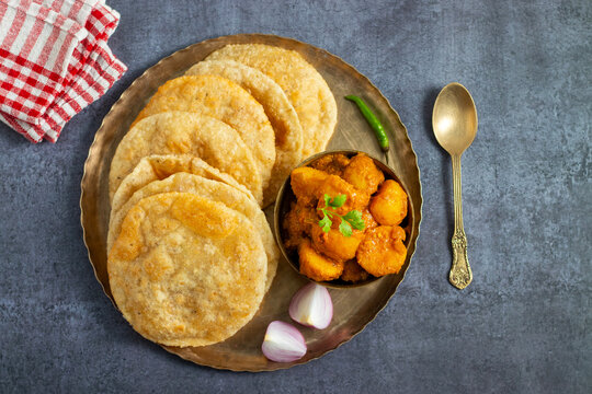 Radha Ballavi is a stuffed Bengali puri filled with spiced lentils, served hot with flavorful alur dom, making a delicious and festive breakfast combo.
