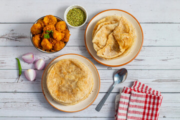 Radha Ballavi is a stuffed Bengali puri filled with spiced lentils, served hot with flavorful alur...