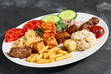 Shashlik mix platter with beef, chicken, kebabs, vibrant vegetables under bright lighting, overhead composition