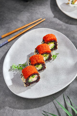 California maki rolls with black rice and tobiko, bright lighting, overhead composition