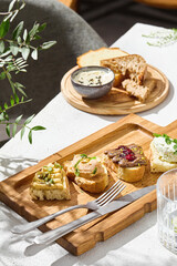 Bruschetta assortment with pate and hummus, bright natural lighting, overhead composition