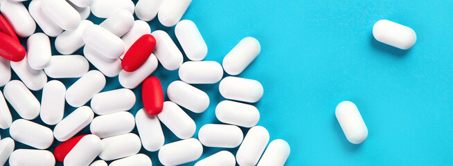 Heap of pills on blue background