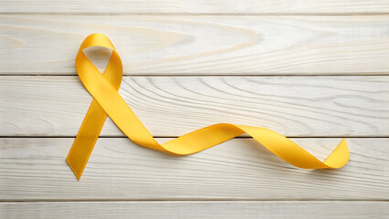 🎗️ Golden Awareness Ribbon: A single, elegant golden ribbon curls gracefully against a backdrop of textured, light-toned wood, symbolizing support, hope, and remembrance.