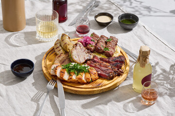 Grilled meat platter with chicken fillet, ribeye steak, kebabs, sausage, tongue, bright lighting,...