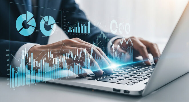 Hands typing on laptop with holographic financial charts and data visualizations overlay