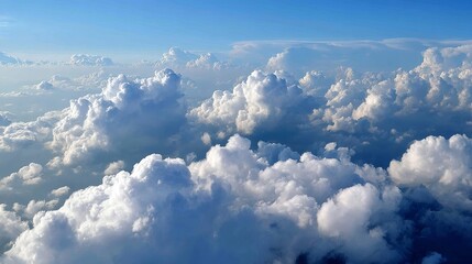 Fototapeta premium Stunning aerial view of fluffy cumulus clouds forming intricate patterns over endless vibrant blue sky, creating a peaceful and aweinspiring atmosphere