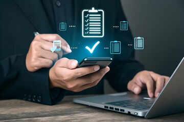 A professional manages digital compliance and verifies documents using a smartphone and laptop for efficient business processes.
