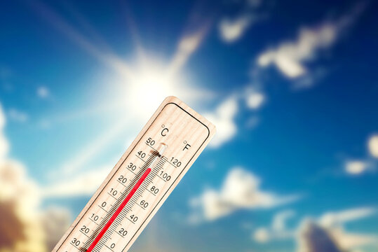 Sun, blue skies and a thermometer that shows high temperatures in summer