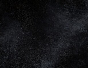 Dark textured surface with speckled dust