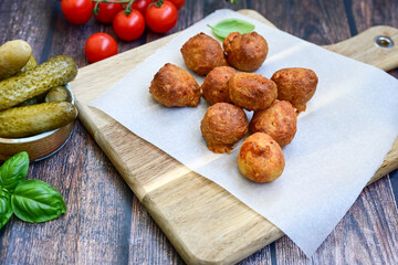 Mini cheese  burger balls.  Ball shaped snack with meat, pickled cucumbers and tomato on wooden background
