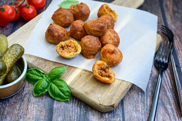 Mini cheese  burger balls.  Ball shaped snack with meat, pickled cucumbers and tomato on wooden background