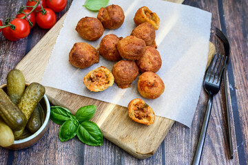 Mini cheese  burger balls.  Ball shaped snack with meat, pickled cucumbers and tomato on wooden background