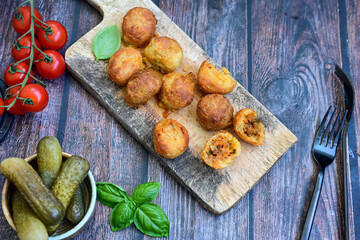 Mini cheese  burger balls.  Ball shaped snack with meat, pickled cucumbers and tomato on wooden background