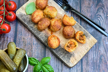 Mini cheese  burger balls.  Ball shaped snack with meat, pickled cucumbers and tomato on wooden background