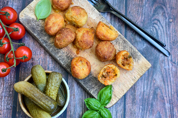 Mini cheese  burger balls.  Ball shaped snack with meat, pickled cucumbers and tomato on wooden background