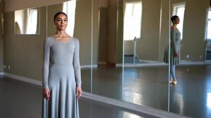 Ballet dancer posing in dance studio mirror - Powered by Adobe
