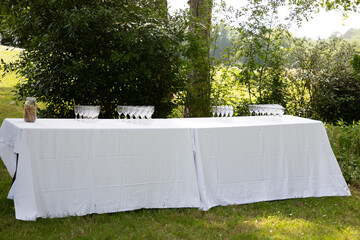 festive table setting with empty glasses for coktail outdoors banquet on terrace restaurant in...