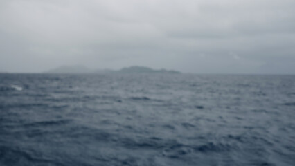 Sailing on a boat around Seychelles island on a foggy day