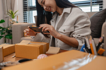 she in an entrepreneur, she sells product online, she own a small business that sell product online, sme, a lot of parcel stack in the room, working in her shopping online storage