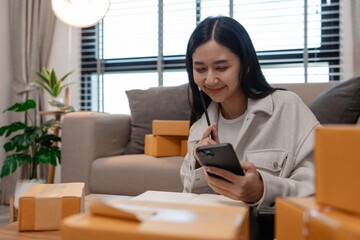 she in an entrepreneur, she sells product online, she own a small business that sell product online, sme, a lot of parcel stack in the room, working in her shopping online storage